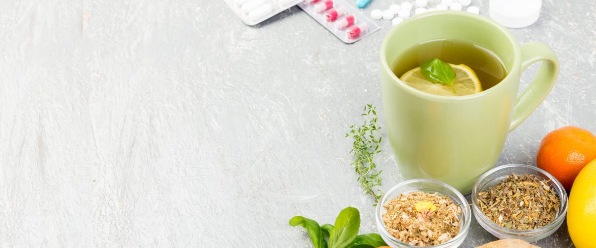 Alternative remedies and traditional pills to treat colds and flu. Natural medicine vs conventional medicine concept. Copy space.