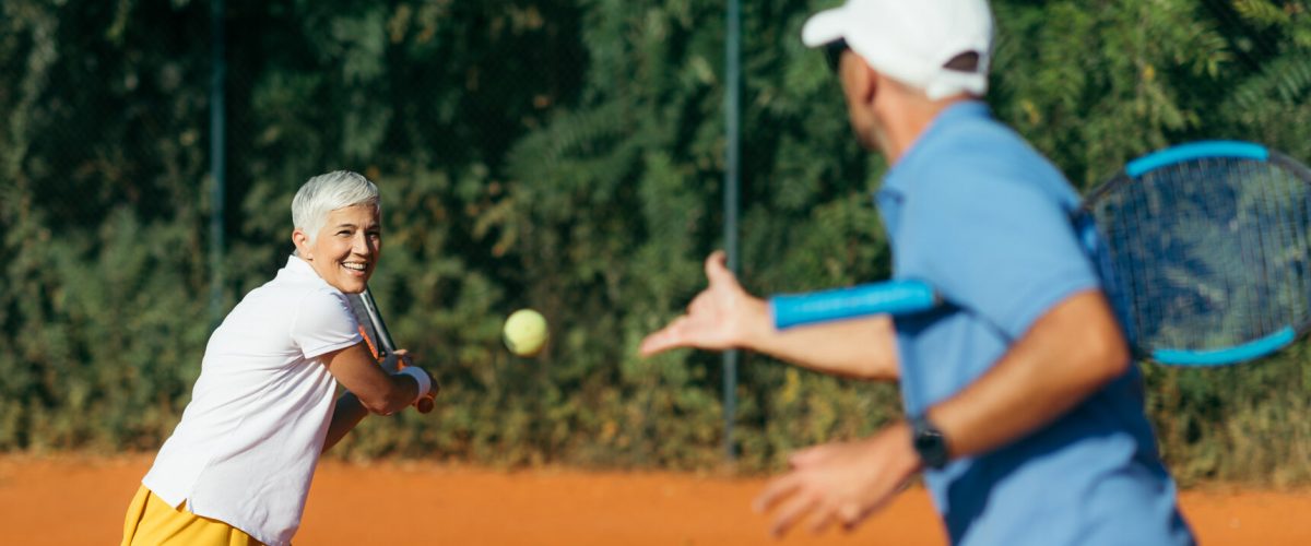 Active Senior Woman Practicing Tennis