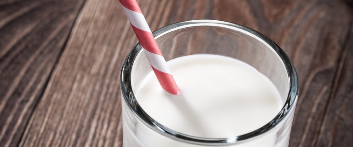 Glass of milk on wooden table