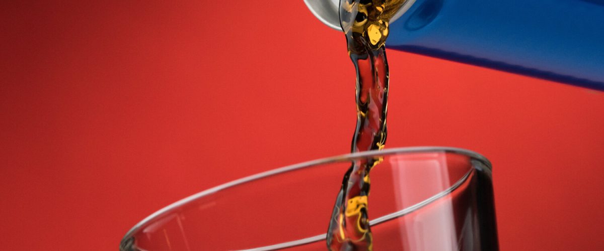 Pouring a refreshing sugary soft drink from a can into a glass